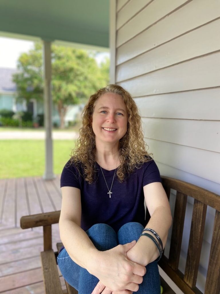 LaKrisha smiling sitting on bench