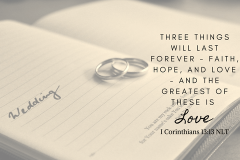 wedding rings lying on open book 1 Corinthians 13:13