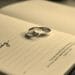 wedding rings lying on open book