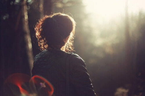 back view of woman sitting in the sun