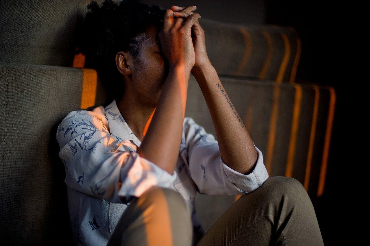 woman sitting against sofa